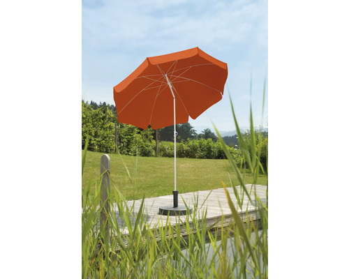 Oranje parasol op een houten terras in de tuin