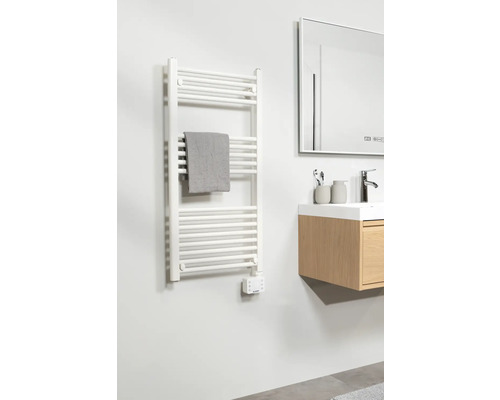 Badkamer met witte radiator, handdoek en wastafel