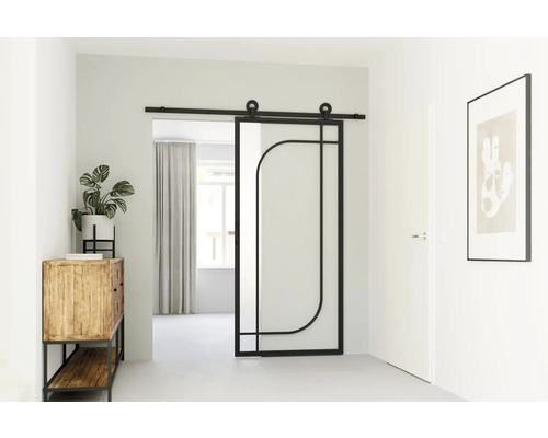 Interieur met schuifdeur in geometrisch design, commode, kamerplant en ingelijste afbeelding.