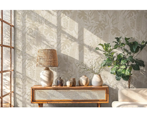 Woonkamer met botanisch behang, lamp, decoratie en plant op een houten kast.