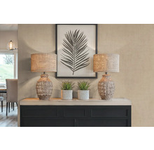 Decoratieve scène met twee tafellampen, planten en een ingelijste bladprint op een dressoir