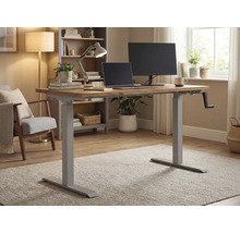 In hoogte verstelbaar bureau met handmatige slinger, laptop en monitor in een lichte kamer.