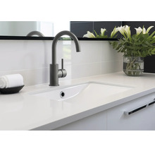 Badkamer wastafel met kraan, handdoek en bloemenvaas