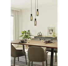 Eettafel met servies, stoelen en hanglamp met drie lampen