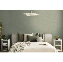 Moderne slaapkamer met saliegroen behang met textuur, wit bed met sierkussens, bloemvormige hanglamp en minimalistische nachtkastjes.