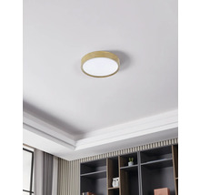 Plafondlamp met houten rand in een heldere, moderne kamer