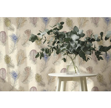 Vliesbehang met pauwenverenpatroon, daarvoor een bijzettafel met eucalyptustakken in een glazen vaas.