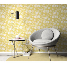 Woonkamer scène met geel bloemenbehang, fauteuil, vloerlamp en bijzettafel