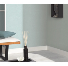 Detailopname van een ingerichte woonkamer met bank, geurstokjes en wanddecoratie