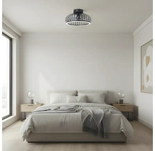 Slaapkamer met plafondlamp in rasterlook en LED-ring.