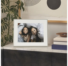 Eenvoudige fotolijst met passe-partout op een dressoir, met een foto van twee kinderen.