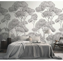 Slaapkamer met behang met boommotief, bed, stoel en nachtkastje