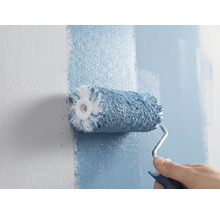 Iemand schildert een muur met een verfroller.