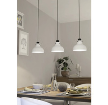 Eettafelscène met drie witte hanglampen boven de tafel