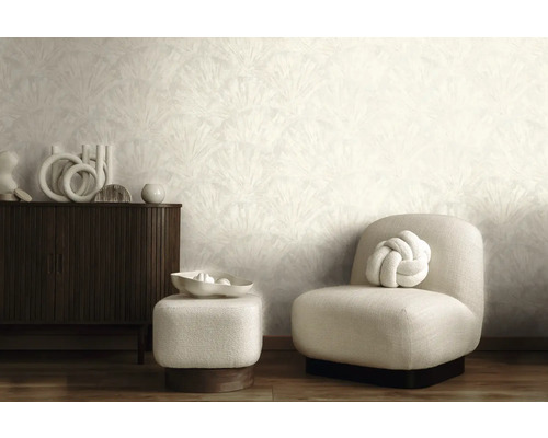 Moderne woonkamer met licht behang met patroon, donker houten dressoir, lichte gestoffeerde fauteuil en bijpassende hocker.