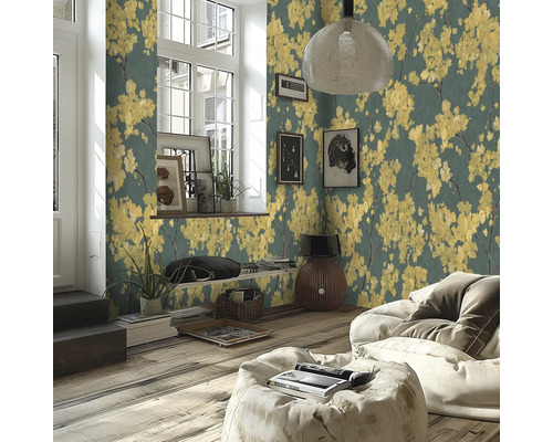 Moderne woonkamer met vliesbehang met gele bloesem op een donkere achtergrond, houten vloer en lichte zitzak.