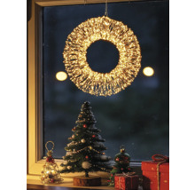 Verlichte LED-kerstkrans voor het raam met feestelijke decoratie, kerstboom en cadeaus.