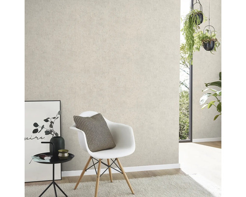 Gestructureerd vliesbehang in een moderne kamer met witte kuipstoel, bijzettafel en hangende planten.