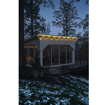 LED-ijspegelverlichting warmwit aan een modern tuinhuis in een winterse omgeving 's nachts.