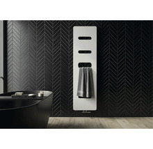 Moderne witte paneelradiator aan een zwart betegelde wand in visgraatmotief in een badkamer met een donker ligbad.
