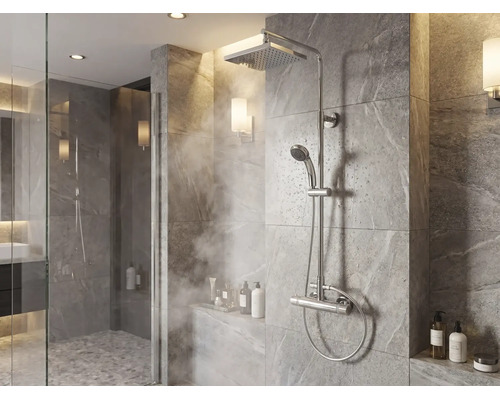 Modern douchesysteem met regendouche, handdouche en thermostaatkraan in een betegelde douche met steeneffect.