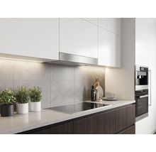 Moderne keuken met witte bovenkasten, roestvrijstalen afzuigkap, grijze achterwand, donkere onderkasten en een kookplaat.