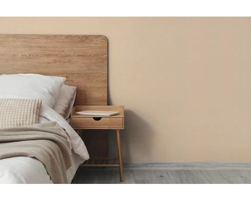 Moderne slaapkamer met beige muur, houten hoofdbord, nachtkastje en licht beddengoed.