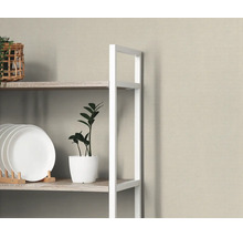 Moderne stellingkast met wit metalen frame en planken in houtlook, gedecoreerd met borden, een kamerplant en een gevlochten mand.