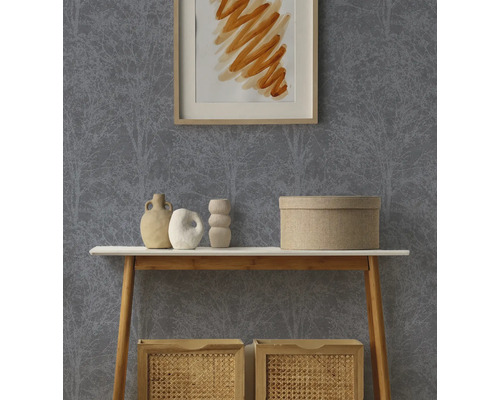 Behang met donker bomenpatroon op een wand achter een consoletafel met decoratie en opbergboxen.