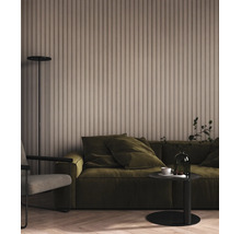 Vliesbehang met verticaal lamellenpatroon in beige in een woonkamer met groene bank en een modern interieur.