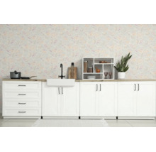 Lichte keuken met witte kasten, keramische spoelbak, zwarte kraan en bloemetjesbehang in landelijke stijl.