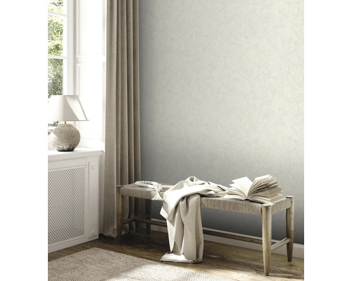 Behang met textuur in een lichte kamer met een houten bank, een gordijn en een tafellamp.