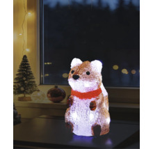 Verlichte acrylfiguur eekhoorn met rode sjaal op een tafel, kerstdecoratie voor binnen met kerstboom op de achtergrond.