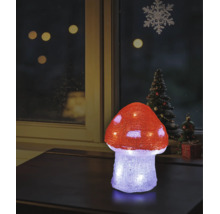 Verlichte LED-decoratie vliegenzwam van acryl op een tafel, kerstvensterdecoratie op de achtergrond.