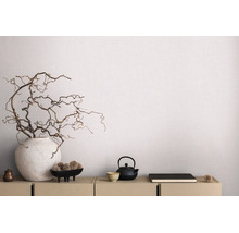 Modern gestructureerd behang in een lichte kamer met dressoir, grote vaas met takken en theepot.