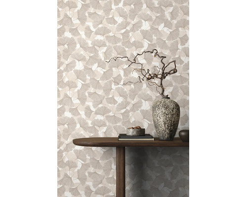 Behang met ginkgobladpatroon in een woonkamer met houten tafel en decoratieve stenen vaas.