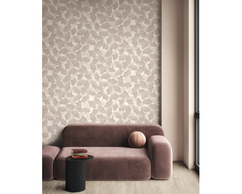 Moderne woonkamer met behang met ginkgobladpatroon, een mauve fluwelen bank en een zwarte bijzettafel op een lichte parketvloer.