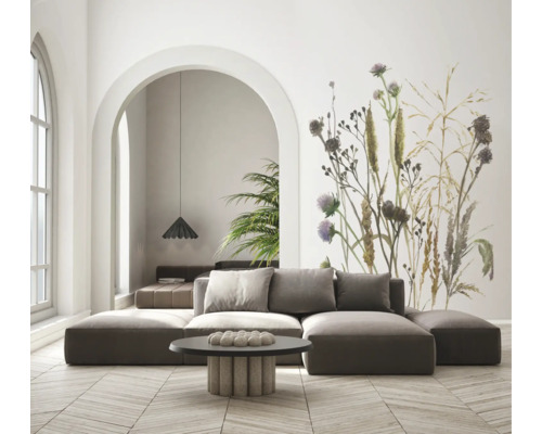 Moderne woonkamer met modulaire bank en een groot fotobehang met botanisch motief van wilde bloemen. Lichte ruimte met houten parketvloer.