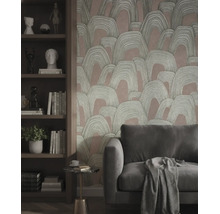 Vliesbehang met abstract boogpatroon achter een bank en een houten kast met boeken en decoratie.