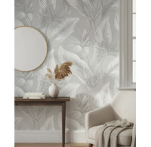 Moderne kamer met behang met bladmotief, houten consoletafel, fauteuil en ronde spiegel. Lichte en georganiseerde sfeer.