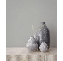 Drie decoratieve vazen in verschillende maten met een grijze natuursteen-look en marmeren textuur op een lichte ondergrond.