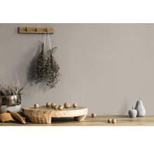 Muurverf in taupe kleur in een rustieke woonomgeving met houten plank, walnoten en gedroogde kruiden.