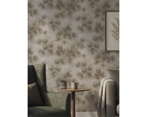 Gestructureerd vliesbehang met een op de natuur geïnspireerd bladerpatroon in een sfeervolle woonkamer met fauteuil en bijzettafel.