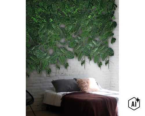 Kunstmatige Monstera bladeren wanddecoratie op een witte bakstenen muur boven een bed in een modern ingerichte slaapkamer. (Image AI modified or generated)