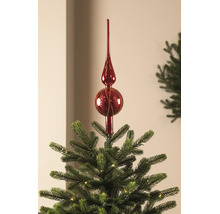 Rode glazen kerstboompiek op de top van een verlichte kerstboom.