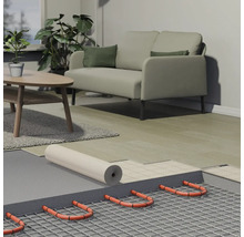 Dwarsdoorsnede van een elektrische vloerverwarming met verwarmingskabels op een mat, ondervloer en laminaat in een moderne woonkamer.