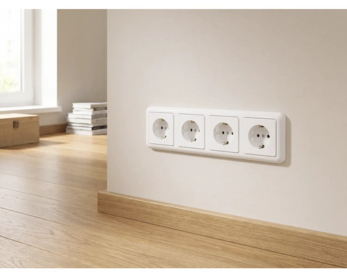 Viervoudig stopcontact op een lichte muur boven een houten plint in een lichte, modern ingerichte kamer.