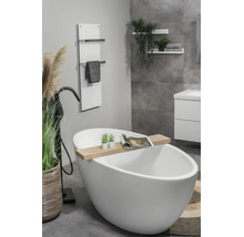 Moderne, lichte badkamer met vrijstaand wit bad, zwarte staande kraan, houten badplank en witte handdoekradiator aan de wand.