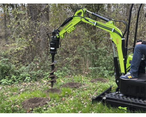 Zipper minigraafmachine met grondboor-hulpstuk bij het graven van gaten in een lichte tuin.