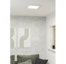 Vierkant LED-plafondpaneel in een moderne woonkamer met grijze wand en minimalistische decoratie.